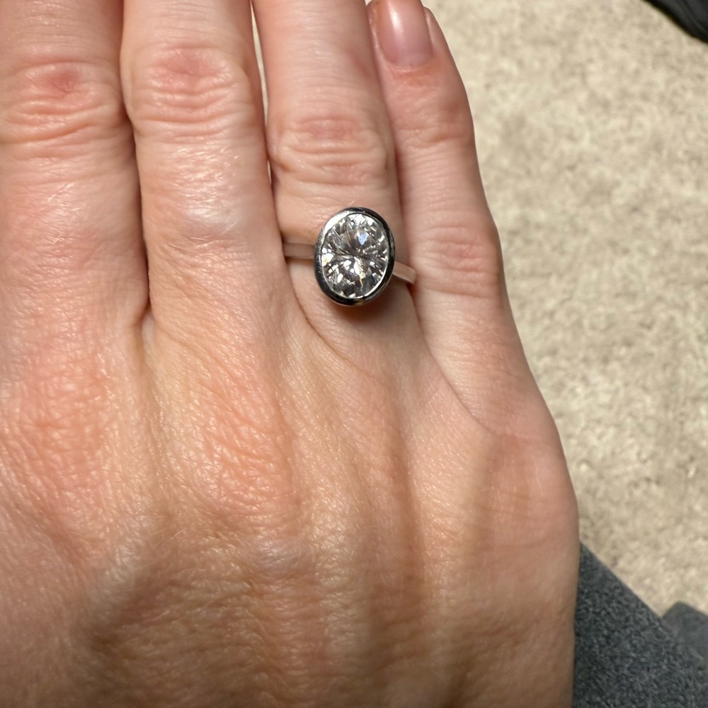 Oval bezel moissanite ring. 2 carats center stone. Size 4.75